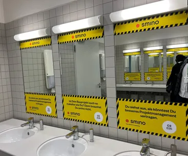 smino mirror advertising in the BAU 2025 toilets